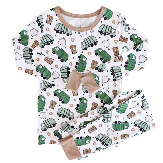 Children's pajama set with green garbage truck pattern on a white background
