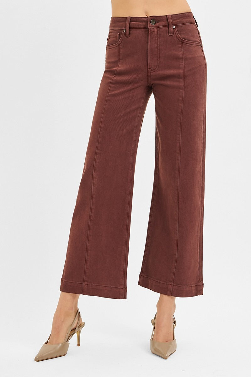 Brown wide-leg jeans on a white background