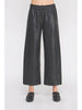 Black leather wide-leg pants worn by a person on a white background