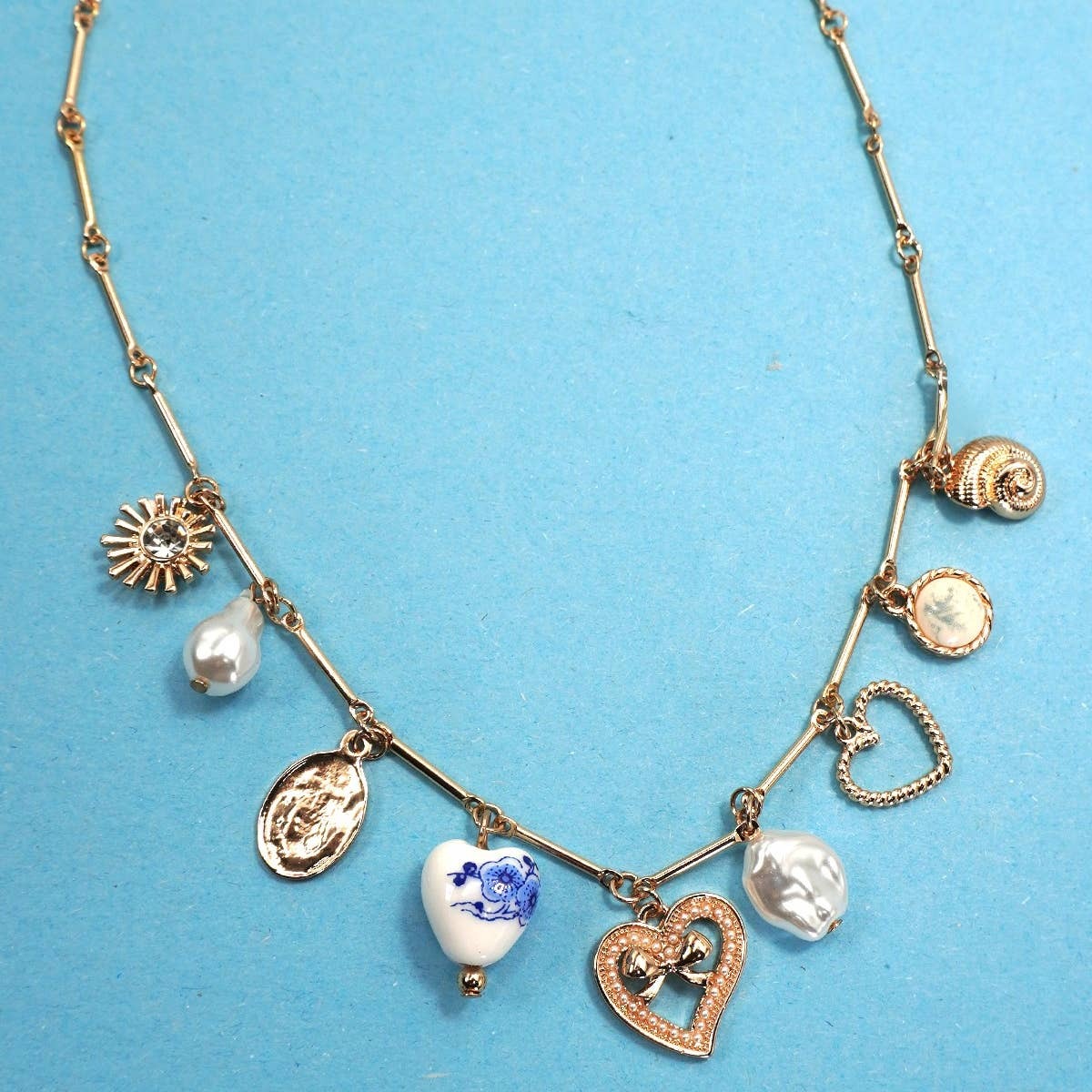 Necklace with various charms on a blue background