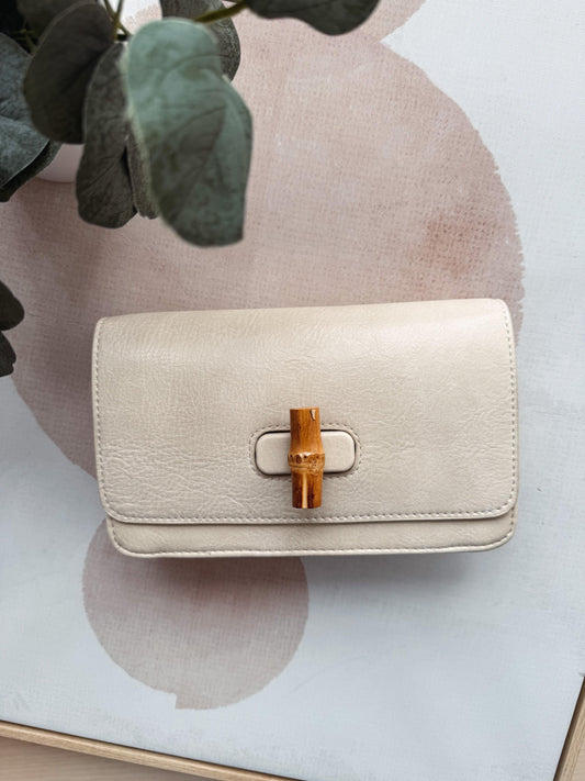 Beige handbag with wooden clasp on a light background