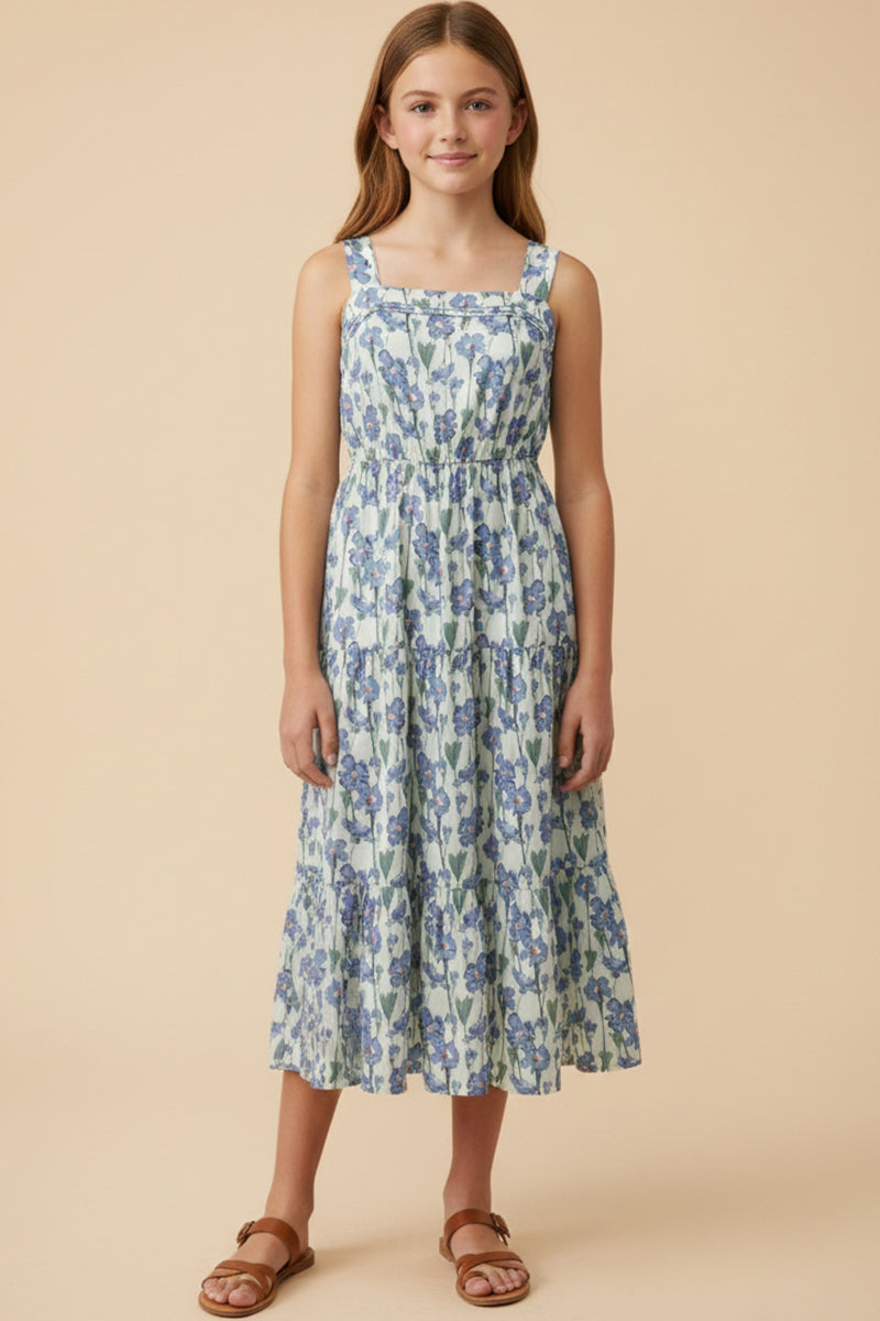 Young girl wearing a floral dress against a beige background