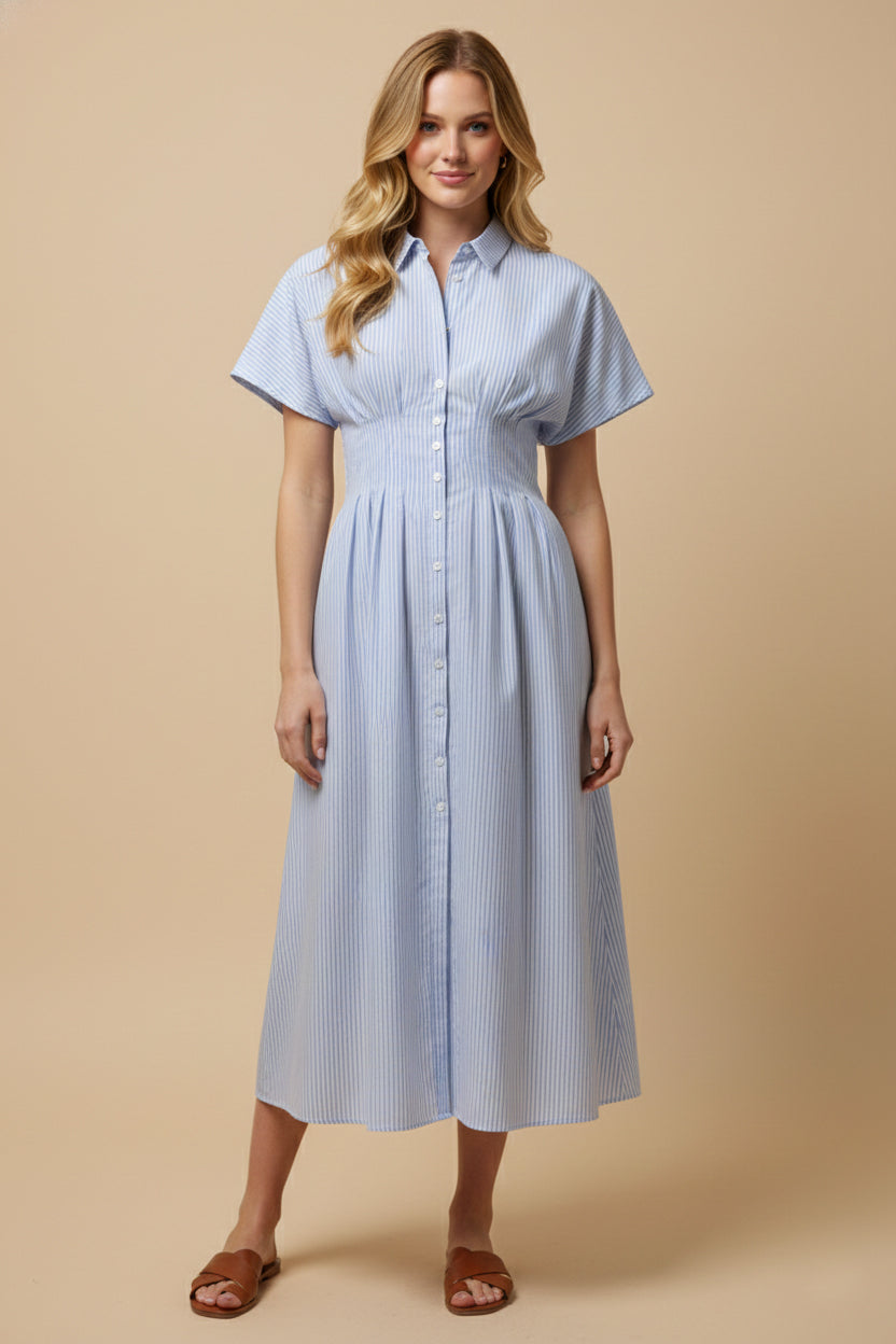 Woman wearing a light blue striped dress against a beige background
