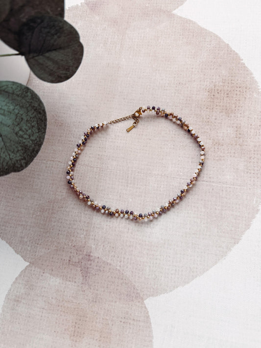 Necklace with small beads on a textured surface