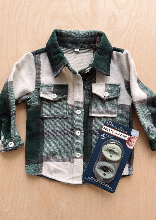 Children's plaid shirt with a package of Sweetie Soothers on a wooden surface