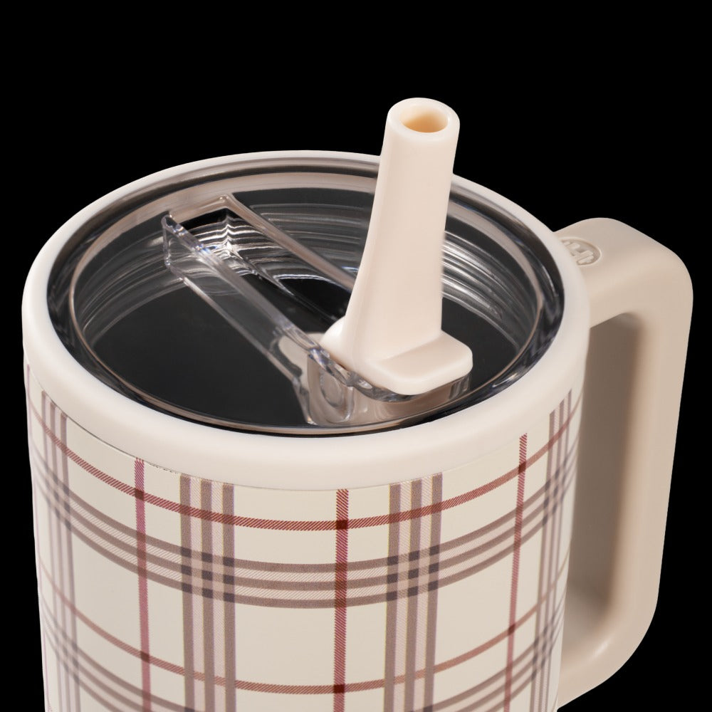 Plaid-patterned mug with a straw lid on a white background