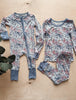 Floral-patterned baby outfit on a wooden surface