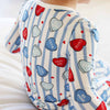 Children's shirt with heart patterns and text on a white background
