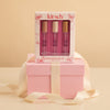 Kit-sch hair perfume trio set with pink packaging on a beige background