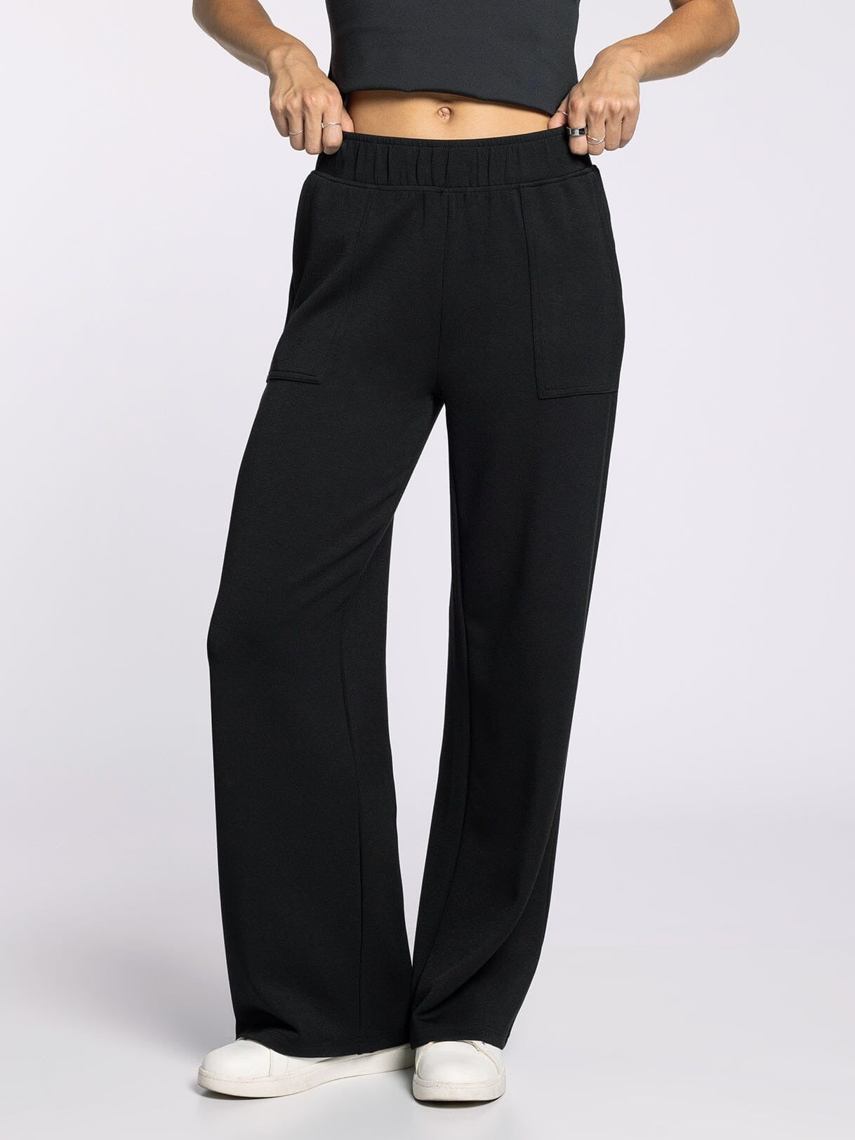 Black wide-leg pants worn by a person on a light gray background