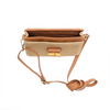 Brown woven handbag with leather strap on a white background
