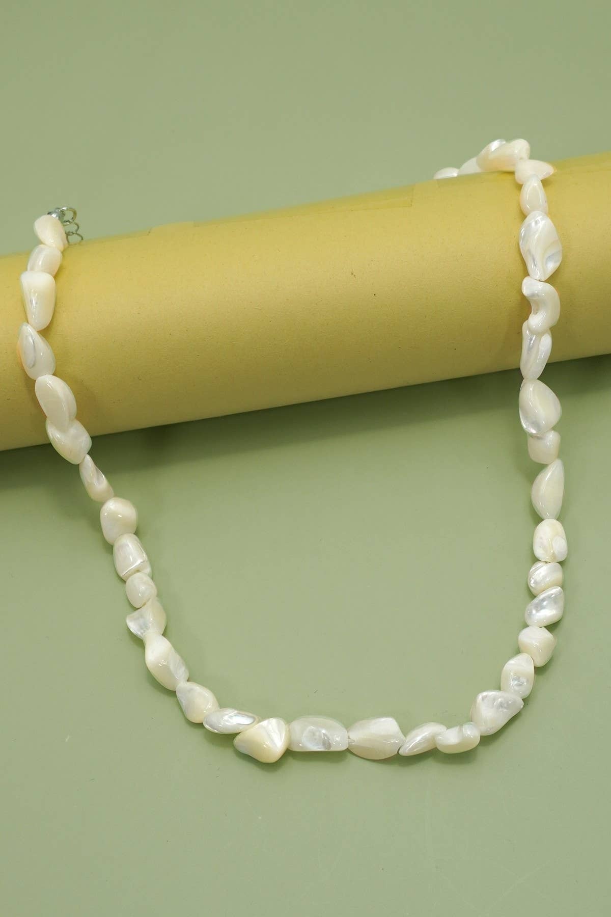 Pearl necklace on a green background