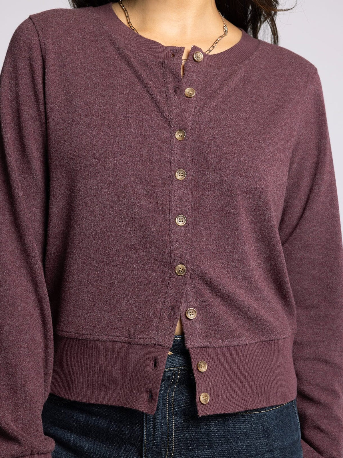 Purple button-up shirt worn by a person on a white background