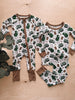 Children's onesie and shirt with truck pattern on a wooden surface