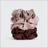 Stack of three scrunchies in brown, pink, and beige on a light gray background