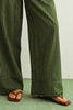 Green striped pants worn by a person on a light green floor.