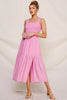 Woman wearing a pink dress against a plain background