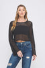 Woman wearing a black mesh top and blue jeans on a white background