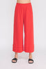 Red wide-leg pants worn by a person on a white background