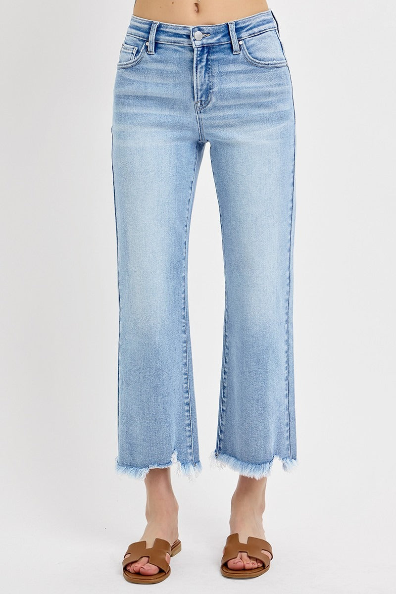 Light blue jeans with a frayed hem on a white background
