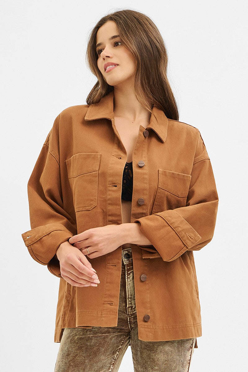 Woman wearing a brown jacket on a white background