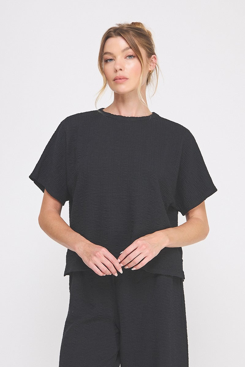 Woman wearing a black outfit on a white background