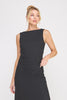 Woman wearing a black sleeveless dress against a white background