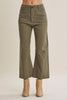 A person wearing olive green wide-leg cropped pants with beige ankle boots, shown from the waist down against a plain light beige studio background.