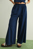 Person wearing navy wide-leg pants on a plain background