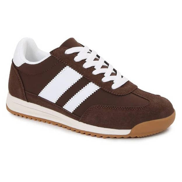 A brown suede low-top sneaker with three white stripes, white laces, a white collar lining, and a gum brown outsole, shown on a plain white background.