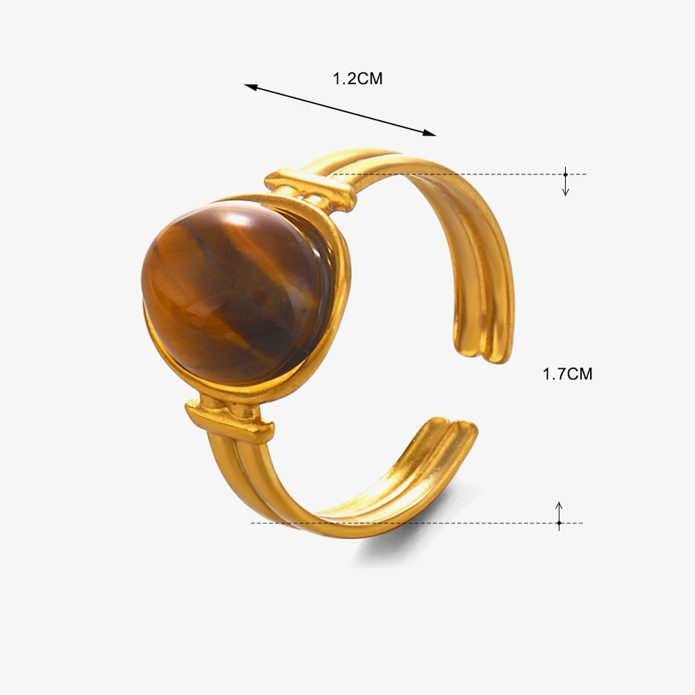 Gold bracelet with a tiger's eye stone and measurements on a white background