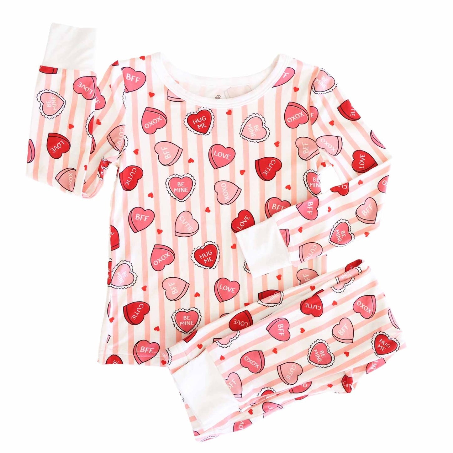 Children's pajama set with heart and stripe pattern on a white background