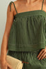 Green and white striped dress worn by a person, with a neutral background