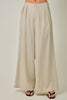 Beige wide-leg pants worn by a person on a white background