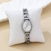 Silver watch with chain strap on a white cushion