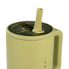 Green mug with straw lid on a white background