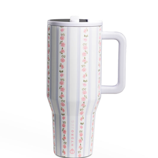 Floral-patterned travel mug with a handle on a white background