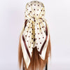 Beige headscarf with brown polka dots on a white background
