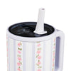 White mug with floral pattern, black lid, and white straw on a white background