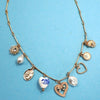 Necklace with various charms on a blue background