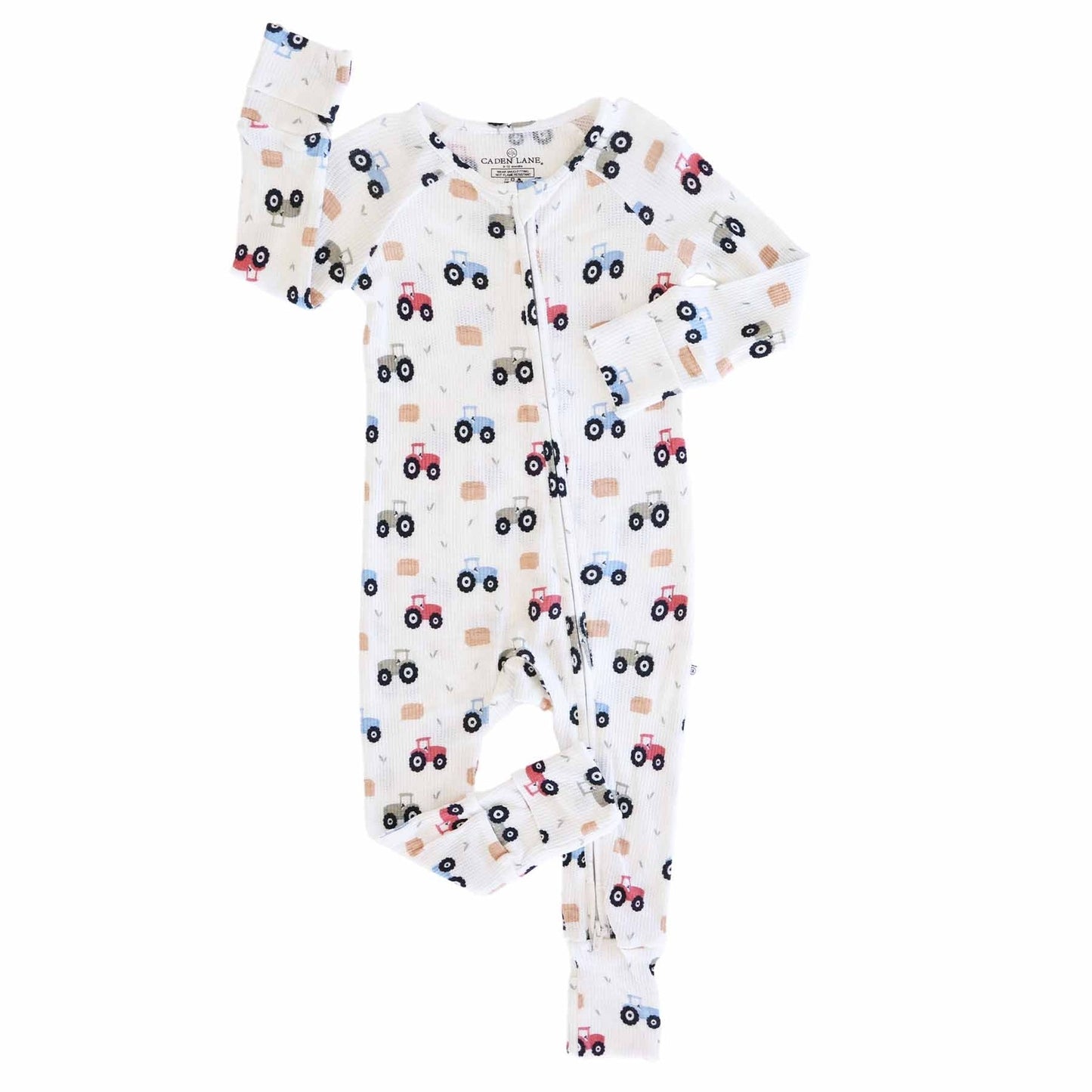 Baby onesie with vehicle pattern on a white background