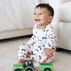 Child playing with a toy truck on a carpeted floor.