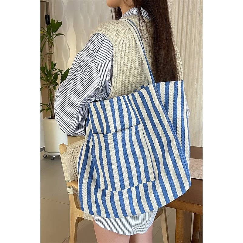 Person wearing a blue and white striped bag indoors