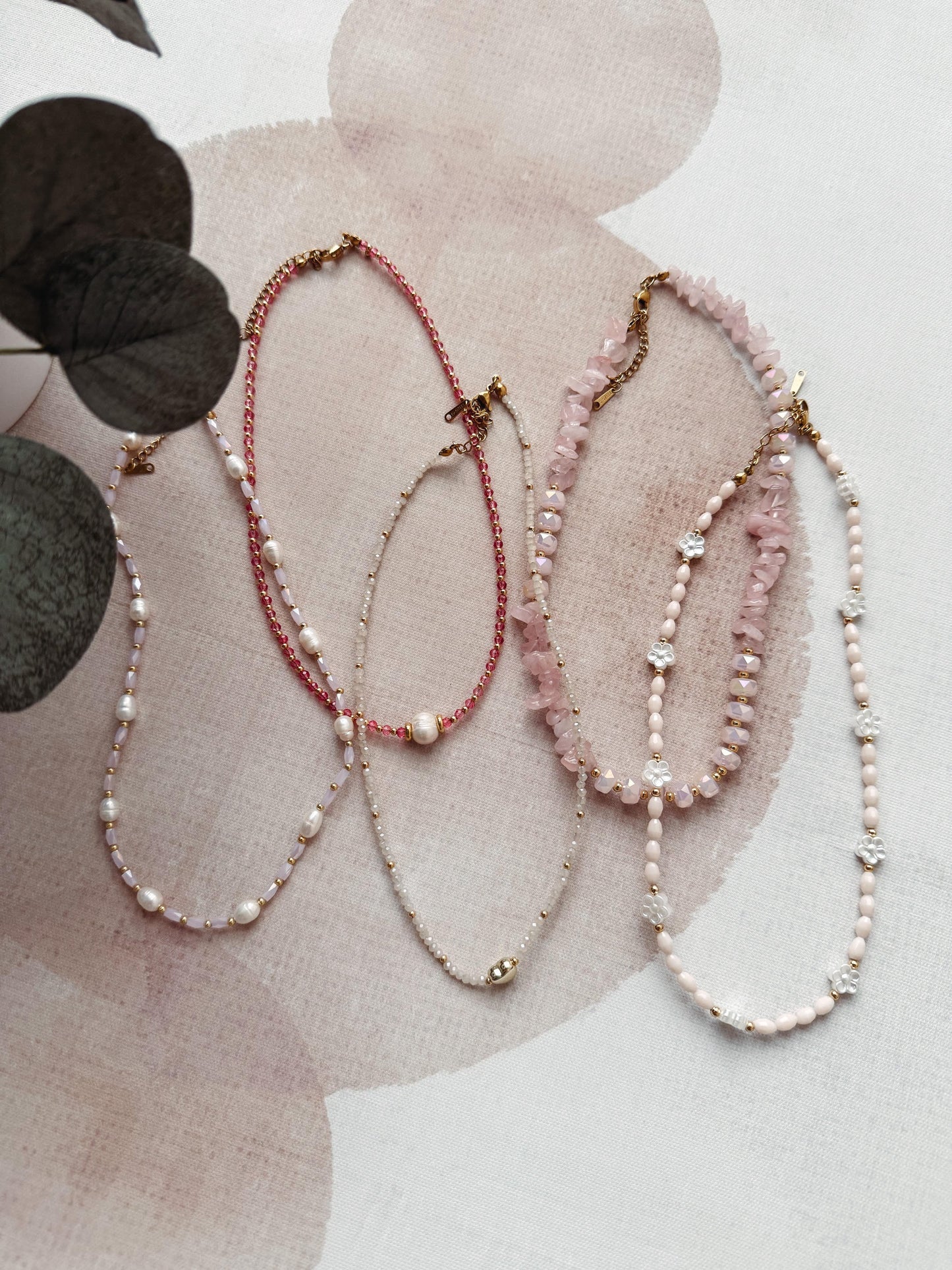 Three pearl necklaces on a floral background