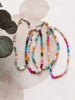 Colorful beaded necklaces on a light background