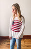 Woman wearing a sweater with a flag design