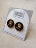 Black and gold rose earrings on a card from Urban Threads Clothing Boutique.