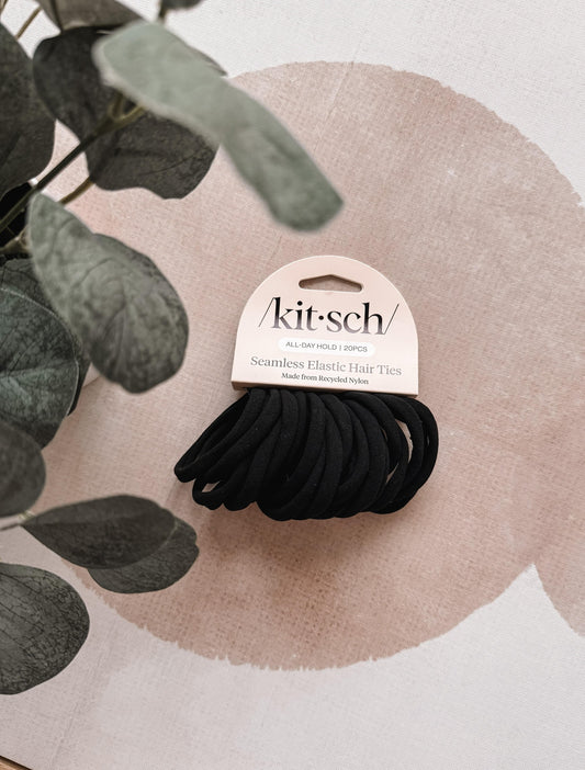 Pack of black hair ties with 'kit-sch' branding on a decorative background