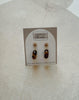 Pair of earrings on a card with 'Urban Threads' branding, displayed on a textured beige surface.