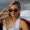 Woman wearing sunglasses with a blurred background